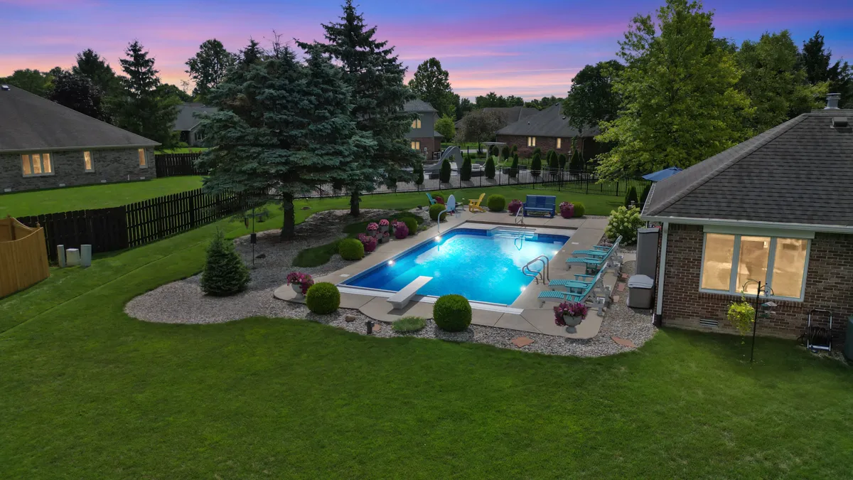 Drone photo of a backyard pool at dusk